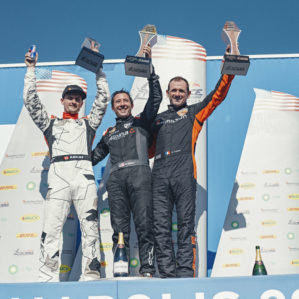 Michael Goulian of the United States (C) celebrates with Pete McLeod of Canada (L) and Nicolas Ivanoff of France (R) during the Award Ceremony at the seventh round of the Red Bull Air Race World Championship at Indianapolis Motor Speedway, Indianapolis, Indiana, United States on October 7, 2018.